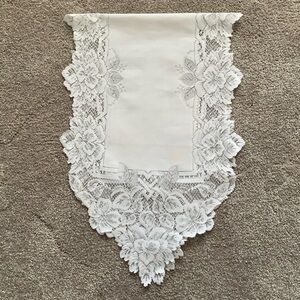 White, lace-trimmed table runner.